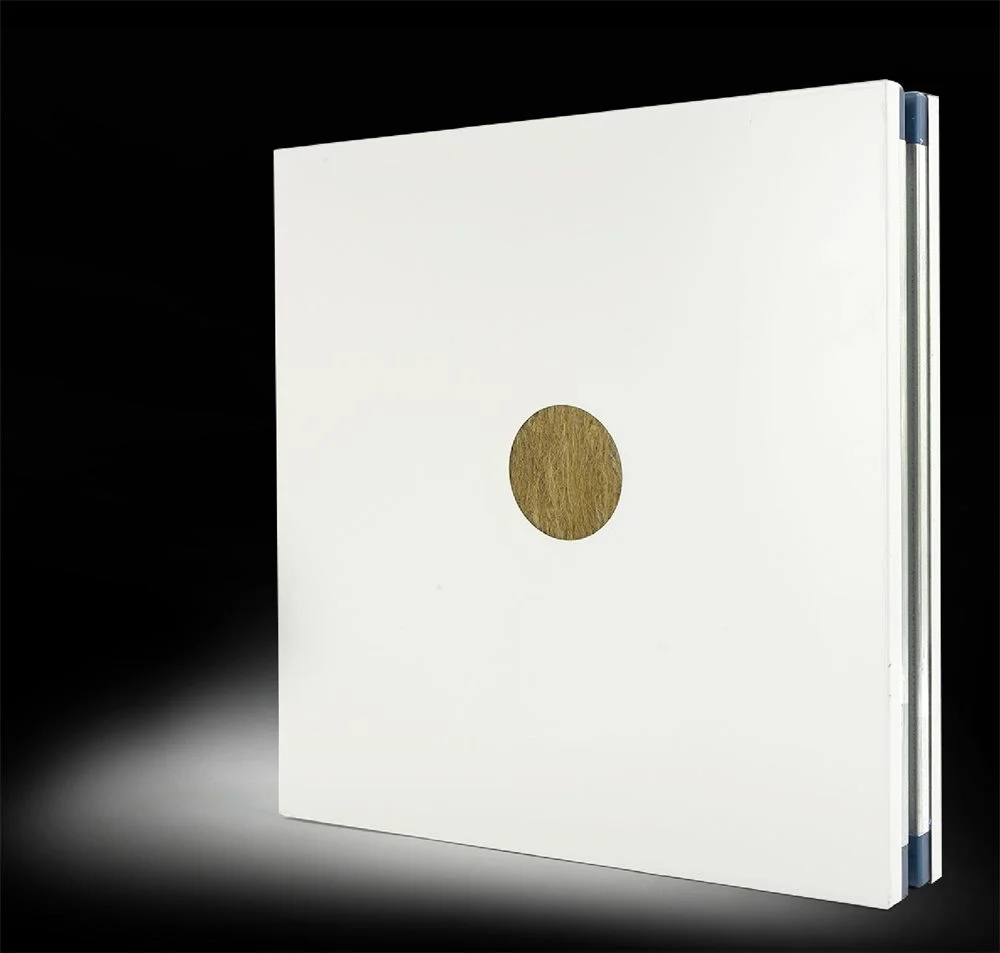 Cut-away of a cleanroom sandwich panel showing a smooth white facing over a rock wool core