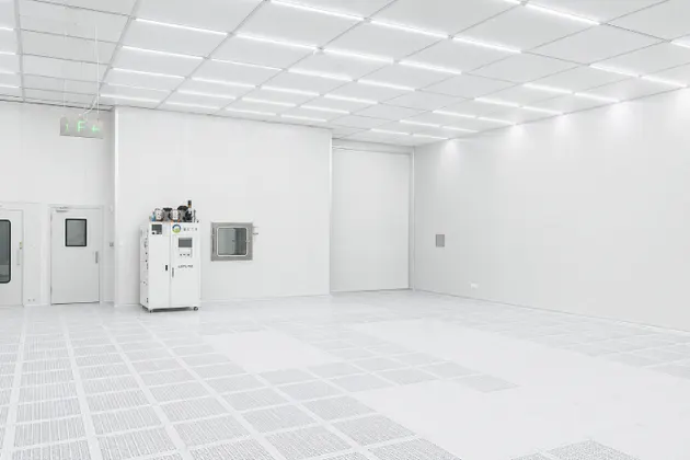 Completed modular biopharma cleanroom interior with sealed panels ceiling grid and raised floor