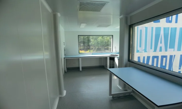 Mobile pharma cleanroom interior with cleanable workbench and controlled clean zone layout
