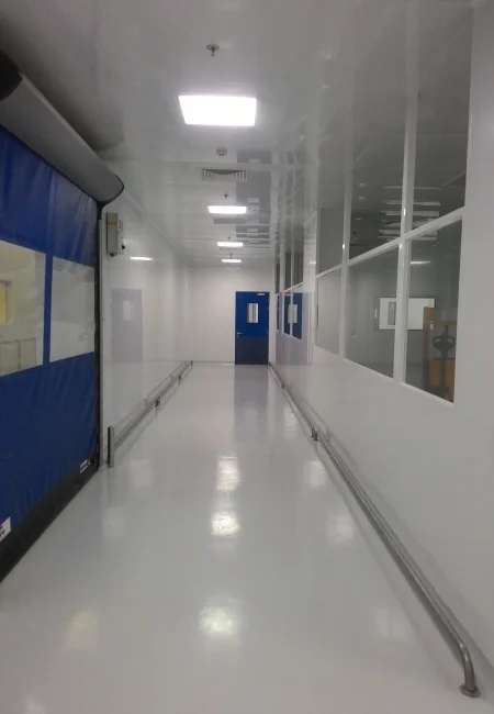 Sterile filling cleanroom corridor with integrated wall panels ceiling lights pressure indicators and cleanroom doors