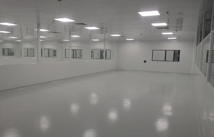 Cleanroom ceiling airflow outlets integrated with white wall panels and observation windows