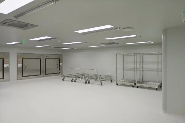 Laboratory animal room interior with cleanroom ceiling panels lighting air outlets and stainless steel transfer carts