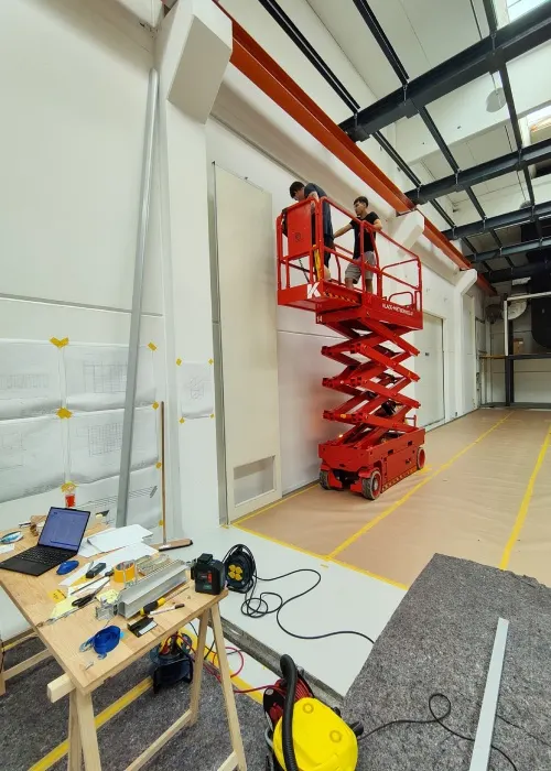 Installers reviewing cleanroom wall drawings during Germany Thomas modular cleanroom construction