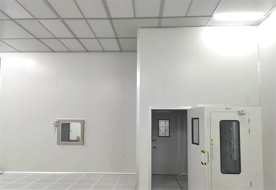 Cleanroom interior with a pass box and air shower built flush into sealed wall panels